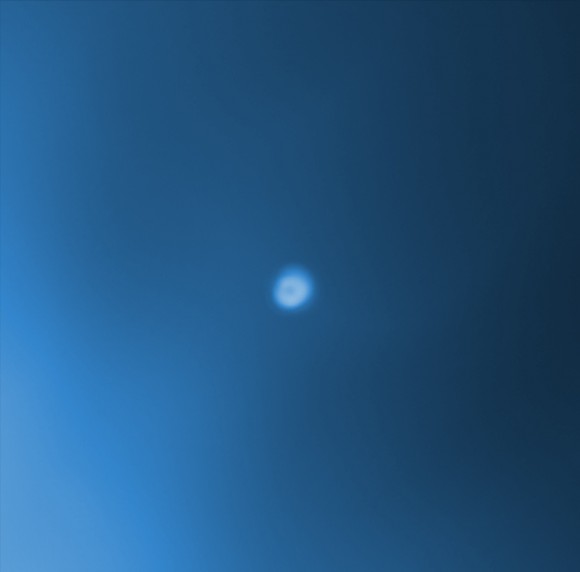 A bright, long duration flare may be the first recorded event of a black hole destroying a star in a dwarf galaxy. The dwarf galaxy is located in the galaxy cluster Abell 1795, about 800 million light years from Earth. A composite image of the cluster shows Chandra data in blue and optical data from the Canada-France-Hawaii Telescope in red, green and blue. An inset centered on the dwarf galaxy shows Chandra data taken between before and after 2005. The X-ray flare provides evidence that a large black hole has pulled in debris from a star that was torn apart by tidal forces.