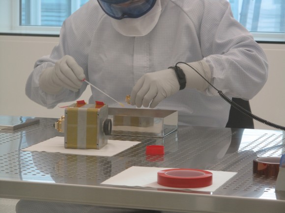 A technician does a check for contamination on the ExoMars 2016 descent camera in December 2013. The test took place at the European Space Agency's European Space Research and Technology Centre in the Netherlands. Credit: ESA