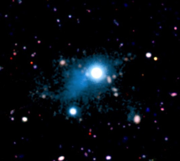 A nebula (seen in cyan) that is about two million light-years across. It was found surrounding the bright quasar UM287 (center). Credit: S. Cantalupo (UCSC)