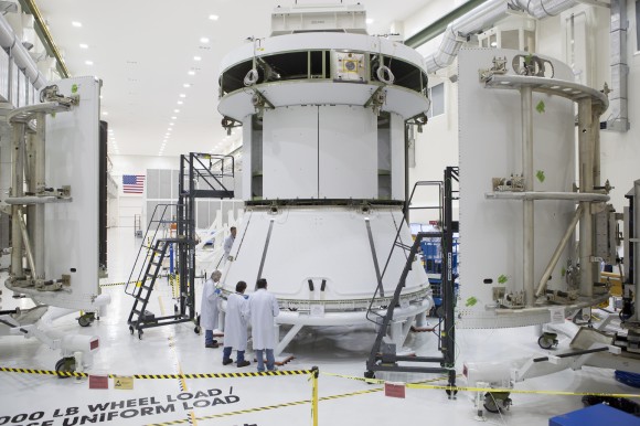 Engineers prepare Orion’s service module for installation of the fairings that will protect it during launch this fall when Orion launches on its first mission. The service module, along with its fairings, is now complete. Credit: NASA