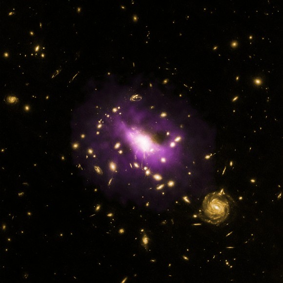 A composite image (X-ray and optical wavelengths) showing galaxy cluster RX J1532.9+3021 and the black hole at its center. Credit: X-ray: NASA/CXC/Stanford/J.Hlavacek-Larrondo et al, Optical: NASA/ESA/STScI/M.Postman & CLASH team