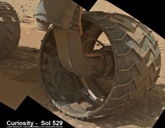 Up close photomosaic view shows lengthy tear in rover Curiosity's left front wheel caused by recent driving over sharp edged Martian rocks on the months long trek to Mount Sharp. Raw images taken by the MAHLI camera on Curiosity's arm on Jan. 31, 2014 (Sol 529) were assembled to show some recent damage to several of its six wheels   Credit: NASA / JPL / MSSS / Marco Di Lorenzo / Ken Kremer- kenkremer.com  See below complete 6 wheel mosaic and further wheel mosaics for comparison