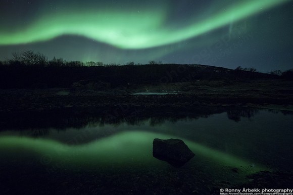 Aurora reflects on water, as seen on February 20, 2014 near Bremnes, Troms Fylke, Norway. Credit and copyright: Ronny Årbekk.