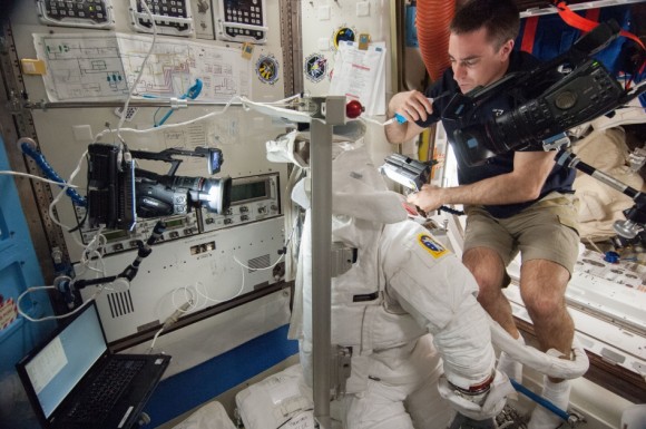 NASA astronaut Chris Cassidy examines a spacesuit during Expedition 36 in August 2013. Credit: NASA