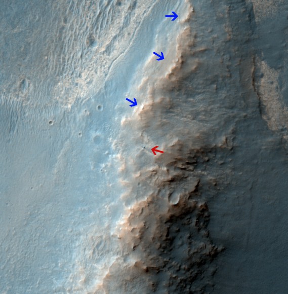 Opportunity Rover on 'Murray Ridge' Seen From Orbit .  The telescopic High Resolution Imaging Science Experiment (HiRISE) camera on NASA's Mars Reconnaissance Orbiter caught this view of NASA's Mars Exploration Rover Opportunity on Feb. 14, 2014.   The red arrow points to Opportunity at the center of the image. Blue arrows point to tracks left by the rover since it entered the area seen here, in October 2013.  The scene covers a patch of ground about one-quarter mile (about 400 meters) wide.  North is toward the top.  The location is the 