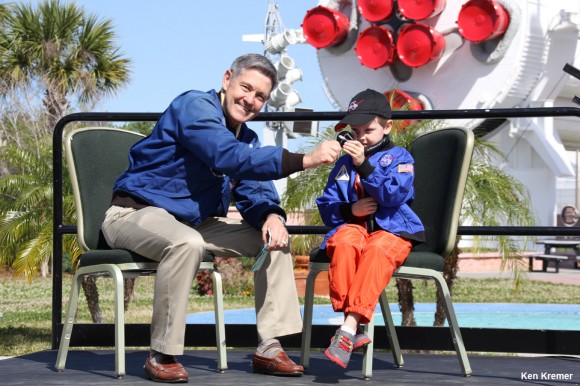 Connor Johnson, 6, talks with former space shuttle commander Bob Cabana, director of Kennedy Space Center, about spaceflight during a ceremony Saturday, March 15, at the Kennedy Space Center Visitor Complex. Connor holds the ISS bolt given to him by Cabana in appreciation of Connor initiating a petition to the White House to maintain NASA funding. Credit: Ken Kremer - kenkremer.com