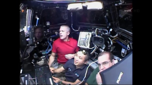 NASA astronaut Steve Swanson, ISS Commander Koichi Wakata and NASA Astronaut Rick Mastracchio work inside the 7 windowed Cupola robotics work station module during Dragon berthing on Easter Sunday morning April 20, 2017. Credit: NASA TV