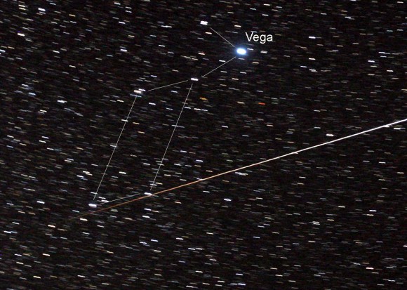 The track of the ISS near Vega in Lyra. From right to left, the station is passing from sunlight into Earth's shadow. Its color transitions from white to red. Credit: Bob King