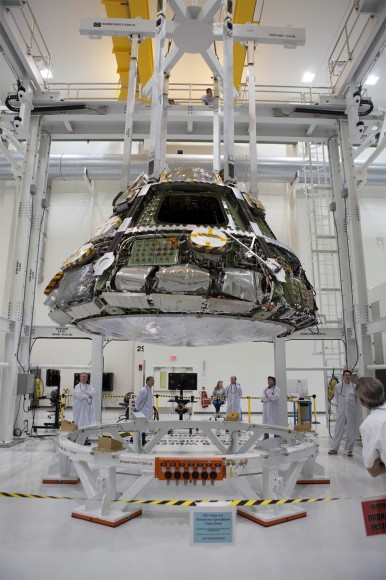 Lockheed Martin and NASA engineers are  installing the largest heat shield ever built onto the Orion spacecraft’s crew module at the Kennedy Space Center. Credit: Lockheed Martin