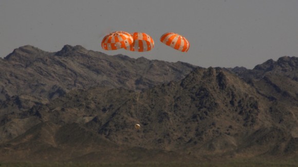 A test version of NASA's Orion manned  spacecraft descends under its three main parachutes above the U.S. Army Proving Ground in Arizona in the agency's most difficult test of the parachutes system's performance to prepare Orion for its first trip to space in December 2014.  Credit:  NASA/Rad Sinyak