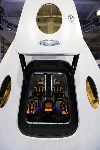 A look through the open hatch of the Dragon V2 reveals the layout and interior of the seven-crew capacity spacecraft. Credit: NASA/Dimitri Gerondidakis