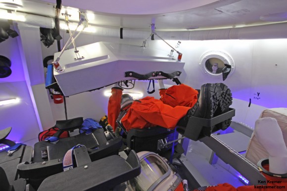 Astronaut mannequin seated below pilot console inside Boeing’s commercial CST-100 'Space Taxi' mockup. Credit: Ken Kremer - kenkremer.com