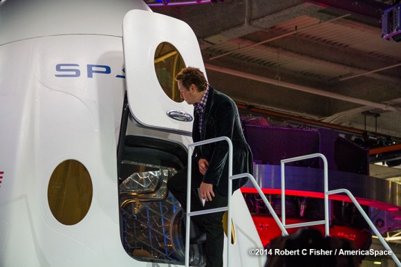 SpaceX CEO Elon Musk pulls open the hatch to ;Enter the Dragon’. Credit: Robert Fisher/America Space