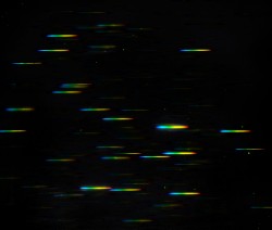This image represents the data that comes from using the NASA/ESA Hubble Space Telescop's highly-sensitive Wide Field Camera 3 in its grism spectroscopy mode. A grism is a combination of a grating and a prism, and it splits up the light from a galaxy into its constituent colours, producing a spectrum. In this image the continuum of each galaxy is shown as a "rainbow". Astronomers can look at a galaxy’s spectrum and identify light emitted by the hydrogen gas in the galaxy. If there are stars being formed in the galaxy then the intense radiation from the newborn stars heats up the hydrogen gas and makes it glow. All of the light from the hydrogen gas is emitted in a small number of very narrow and bright emission lines. For dwarf galaxies in the early Universe the emission lines are much easier to detect than the faint, almost invisible, continuum. Image Credit: NASA and ESA