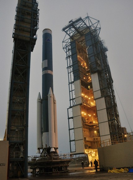 OCO-2's Delta II Rocket, First Stage At Space Launch Complex 2 on Vandenberg Air Force Base in California, the mobile service tower rolls away from the launch stand supporting the first stage of the Delta II rocket for NASA's Orbiting Carbon Observatory-2 mission. Three solid rocket motors (white) have been attached to the first stage. The photo was taken during operations to mate the rocket's first and second stages. Credit: NASA/Randy Beaudoin