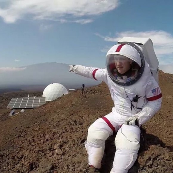 Casey Stedman, commander of the 2014 HI-SEAS mission, points towards its habitat module and Maunea Kea during the Hawaiian mission. Credit: Casey Stedman/Instagram