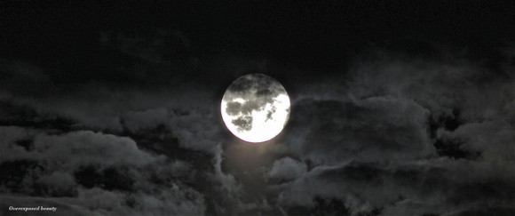 An over-exposed beauty showing the full Moon rising through the clouds on July 12, 2014 near Bromsgrove, England, United Kingdom. Credit and copyright: Sarah and Simon Fisher.