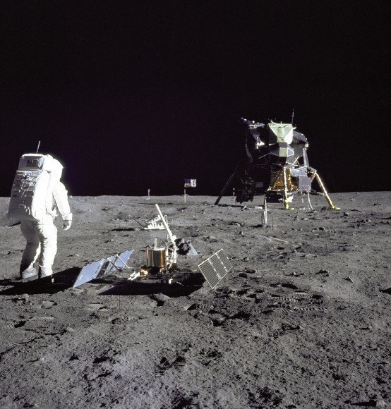Aldrin Gazes at Tranquility Base. Astronaut and Lunar Module pilot Buzz Aldrin is pictured during the Apollo 11 extravehicular activity on the moon. He had just deployed the Early Apollo Scientific Experiments Package. In the foreground is the Passive Seismic Experiment Package; beyond it is the Laser Ranging Retro-Reflector (LR-3). In the left background is the black and white lunar surface television camera and in the far right background is the Lunar Module "Eagle." Mission commander Neil Armstrong took this photograph with the 70mm lunar surface camera. Image credit: NASA