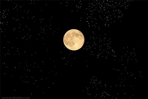 The July 12, 2014 Supermoon or perigee full moon shares the night sky with fireworks from a display in Chester, New York. Credit and copyright: Tom Bushey.
