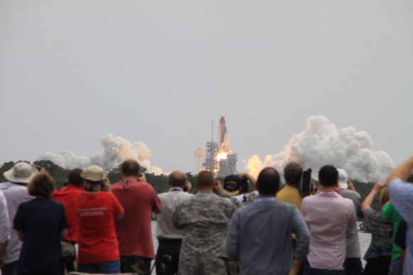 STS-135 Atlantis lifts off on July 8, 2011 with a crowd of people watching the event, the last launch of the shuttle program. Credit: Remco Timmermans