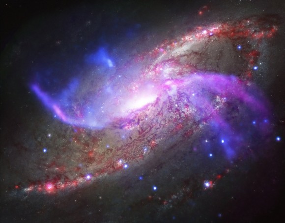 Image of NGC 4258 (M106), a spiral galaxy in the Milky Way. This is a composite image made up of X-rays from NASA's Chandra X-ray Observatory (blue), radio data from the National Science Foundation's Karl Jansky Very Large Array (purple), optical data from NASA's Hubble Space Telescope (yellow) and infrared data from NASA's Spitzer Space Telescope (red). Credit: X-ray: NASA/CXC/Caltech/P.Ogle et al; Optical: NASA/STScI; IR: NASA/JPL-Caltech; Radio: NSF/NRAO/VLA
