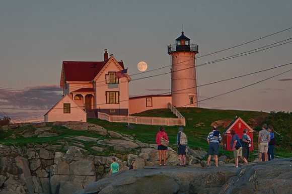 People watch the nearly 'super' Moon rise on August 9, 2014 near a lighthouse. Credit and copyright: Will Nourse.