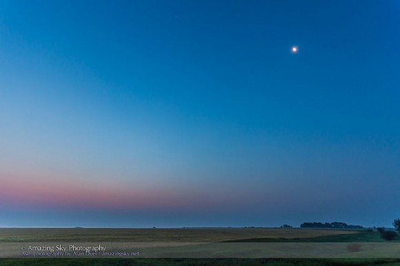 Venus and Jupiter 1/2 degree apart low in the pink twilight at lower left, with the waning crescent Moon near Aldebaran at upper right, taken from Alberta Canada on August 18, 2014 at dawn, looking due east. This is a single 1 second exposure at f/4 with the 16-35mm lens and Canon 6D at ISO 800. Credit and copyright: Alan Dyer/Amazing Sky Photography.