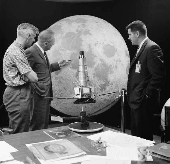 Three members of the Ranger 7 television experiment team stand near a scale model and lunar globe at NASA’s Jet Propulsion Laboratory (JPL). From left: Ewen Whitaker, Dr. Gerard Kuiper, and Ray Heacock. Kuiper was the director of the Lunar and Planetary Laboratory (LPL) at the University of Arizona. Whitaker was a research associate at LPL. Heacock was the Lunar and Planetary Instruments section chief at JPL. Credit: NASA/JPL-Caltech