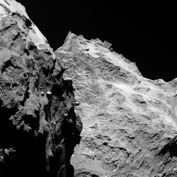 Jagged cliffs and prominent boulders are visible in this image taken by OSIRIS on 5 September 2014 from a distance of 62 kilometres from comet 67P/Churyumov-Gerasimenko. The left part of the image shows a side view of the comet’s 'body', while the right is the back of its 'head'. One pixel corresponds to 1.1 metres. Credits: ESA/Rosetta/MPS for OSIRIS Team MPS/UPD/LAM/IAA/SSO/INTA/UPM/DASP/IDA 