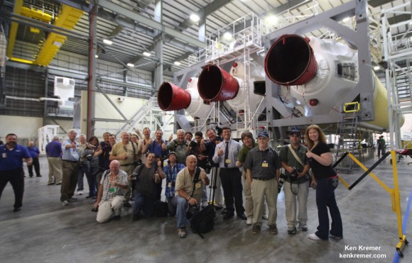 Space journalists including Ken Kremer/Universe Today pose with the Delta IV Heavy rocket resting horizontally in ULA's HIF processing facility at Cape Canaveral that will launch NASA's maiden Orion on the EFT-1 mission in December 2014 from Launch Complex 37.   Credit: Ken Kremer/kenkremer.com