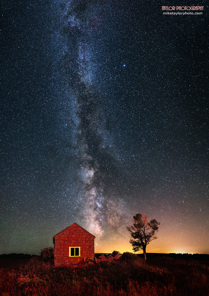 This is a 7 image vertical panorama of the night sky in Maine where the late Summer Milky Way makes a dramatic background for a small shack and tree. Credit and copyright: Mike Taylor/Mike Taylor Photography.