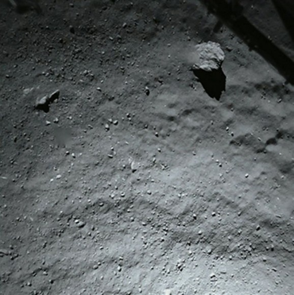 This image was taken by Philae's down-looking descent ROLIS imager when it was about 131 feet  (40 meters) above the surface of the comet. The surface is covered by dust and debris ranging from millimeter to meter sizes. The large block in the top right corner is 16.4 feet (5 m) in size. In the same corner the structure of the Philae landing gear is visible. Credit: ESA/Rosetta/Philae/ROLIS/DLR
