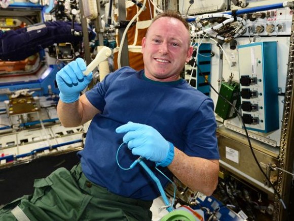 Expedition 42 commander Butch Wilmore holds up a 3-D-printed rachet, the first such tool made in space. Credit: NASA