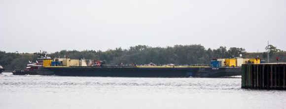 Photo of returning SpaceX ‘autonomous spaceport drone ship’ shows possible damage to onboard gear and possibly a few rocket parts under tarps. Credit: Reddit
